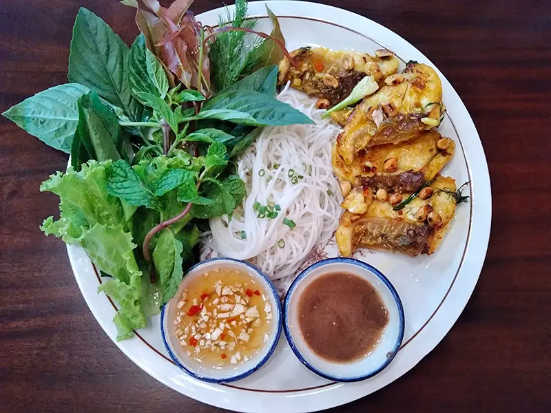 Cha Ca La Vong stir fried sliced sea bass with turmeric & dill on rice noodles