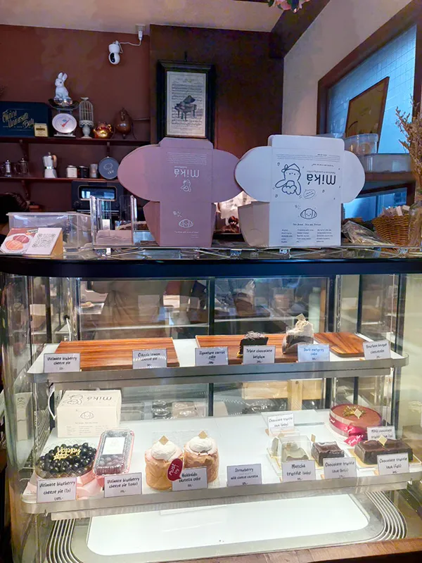 Various cakes lined up in a case